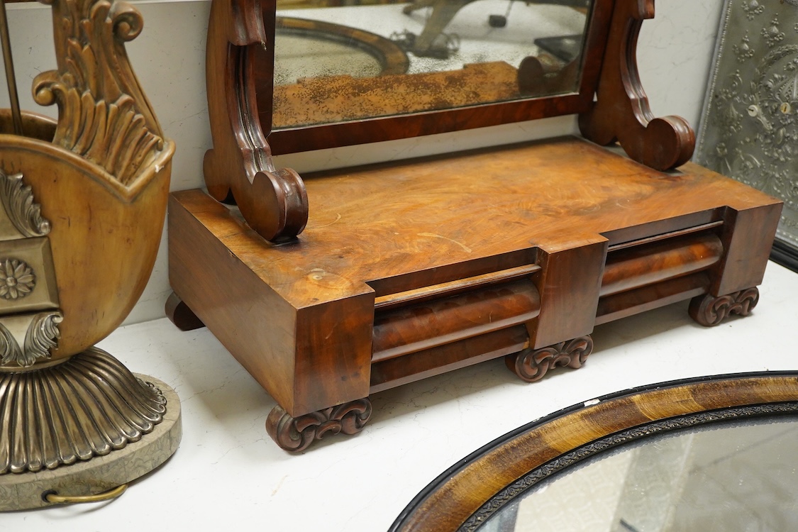 A mahogany toilet mirror and an oval wall mirror, 77cm wide